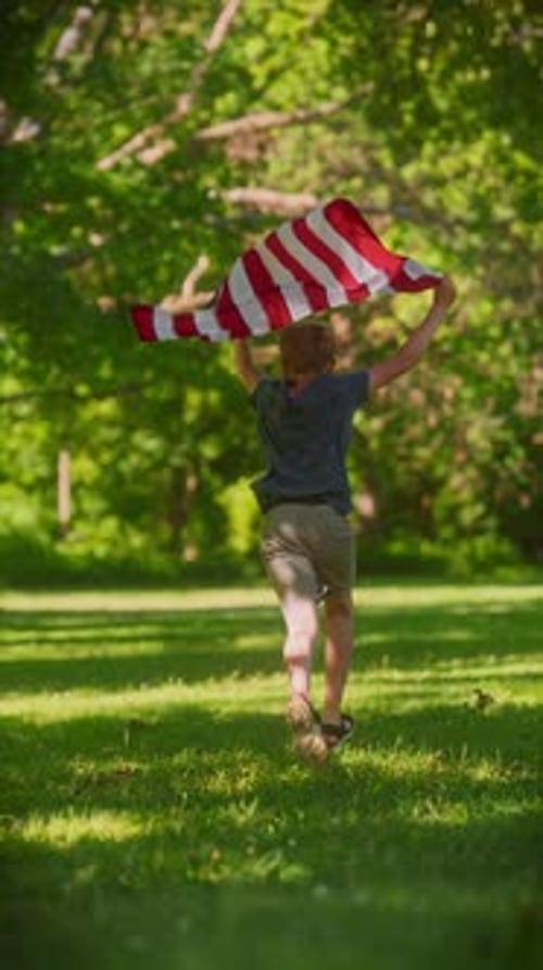 Boy Running with American Flag in Summer Park