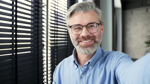 Man Smiling, Talking, and Waving on Video Call