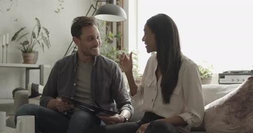 Couple Relaxing at Home With Tablet