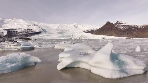 glacial lagoon with floating icebergs under Iceland’s frozen peaks