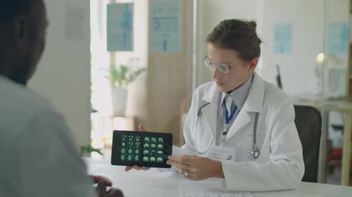 Female Doctor Explaining Brain CT Scan to Patient