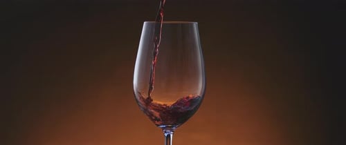 Red Wine Being Poured Into Glass