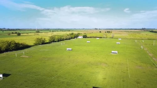 Empty soccer fields with green grass. Nature in the background. Concept of outdoor sport. Drone Aeri