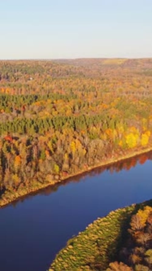 Autumn aerial view of Sigulda, Latvia with colorful forests and a calm winding river