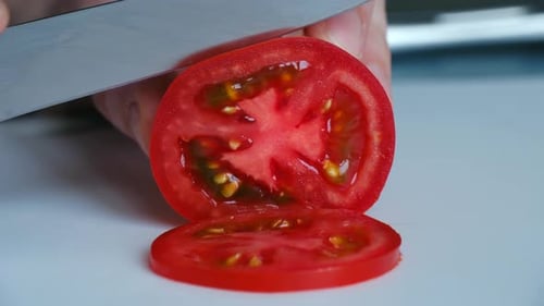 Slicing Fresh Red Tomato on Cutting Board Close-up