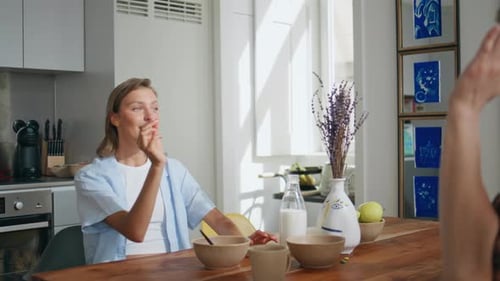 Two Friends Enjoying Breakfast Conversation at Home