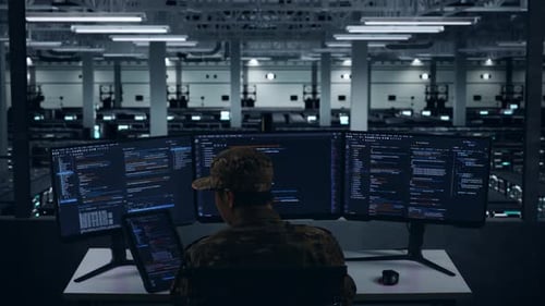 Back View Of Asian Military Working With Tablet While Write Code In Data Center