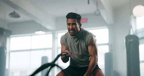 Fitness, rope exercise and a man at gym for body builder training and wellness