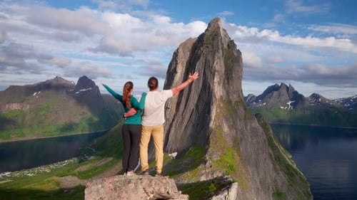 Adventurous travel couple enjoy scenic view of Segla mountain from lookout point
