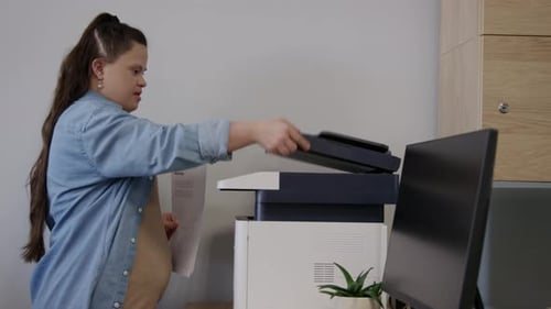 Woman with Down Syndrome Scanning Business Documents in Office