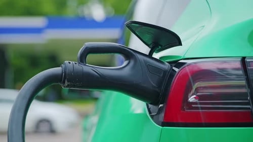 Close Up Electric Car Charging With Green Paint Symbolizing Clean Energy