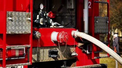Fire Truck with Connected Water Hose Extinguishing Fire