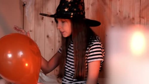Girl in Witch Hat with Balloon