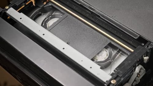 VHS Cassette is Played Inside a VCR Tape Recorder Top View