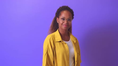 Smiling Woman in Yellow Shirt Posing