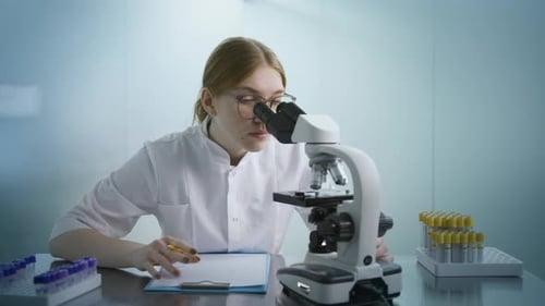 Female Biochemist Working on Microscope on Gene Therapy Medical Treatment