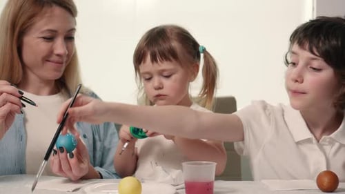 The Family is Painting Easter Eggs