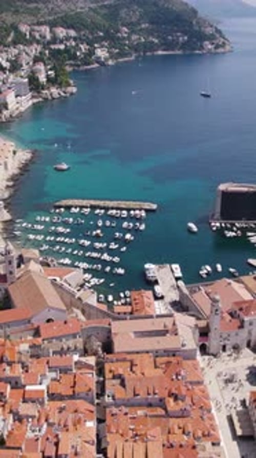 Aerial view of Dubrovnik, Croatia, showcasing the old town harbor and city walls. vertical video