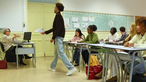 High School Students Handing in Exams to the Teacher in a Classroom