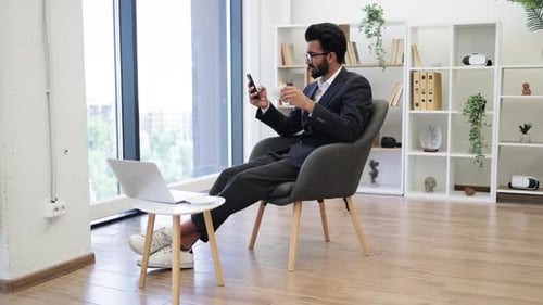 Businessman Relaxing in Modern Office