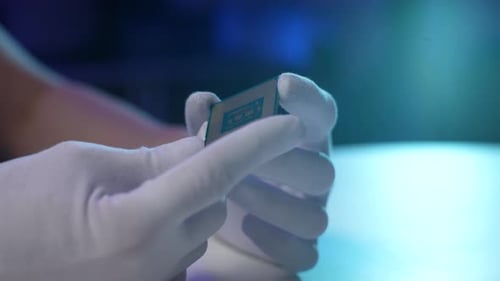 Closeup High Angle View of Unrecognizable Computer Technician in Latex Gloves Holding in Hands CPU