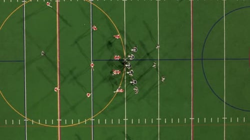 American Football Teams of Play at Night Time Aerial Top Down Zoom Shot