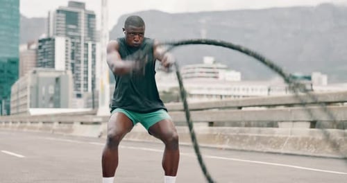 Man, battle ropes and fitness in city for speed workout or health performance for muscle