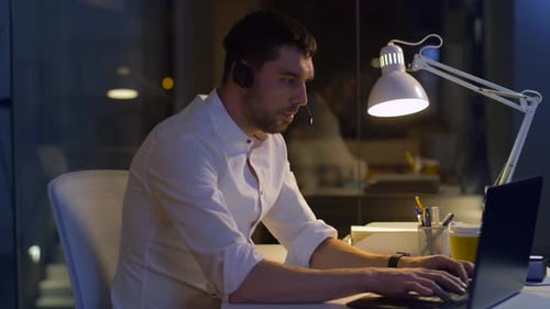 Man working late at computer in office