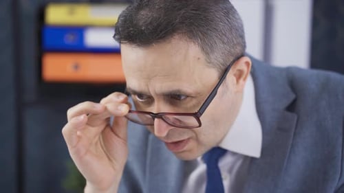 Man in Suit Working Hard in Office