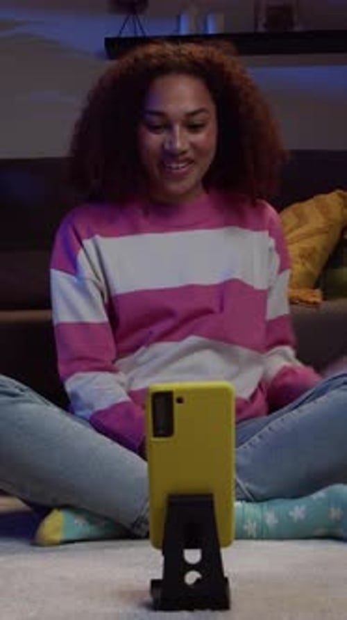 Woman Recording Video with Phone at Night