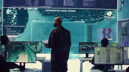 Army Officer Examining Real Time Satellite Data on Big Screen in Military Base