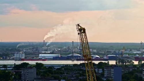 Cranes at the Riga, Latvia port terminal on the Baltic Sea at sunset - drone parallax