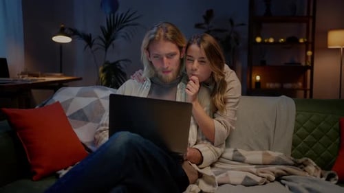 Couple Relaxing at Home Watching Laptop