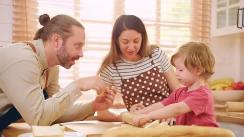 Caucasian attractive couple baking bakery with son in kitchen at home.