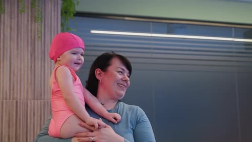 Baby Clinging to Caregiver While Being Carried Around