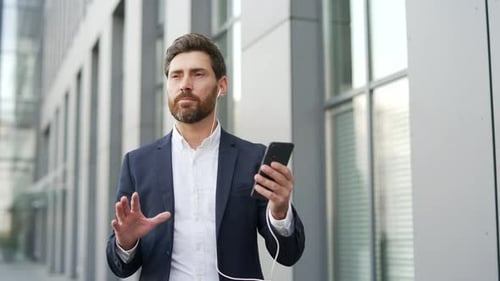 Professional Man Having a Video Call Outside Office Building