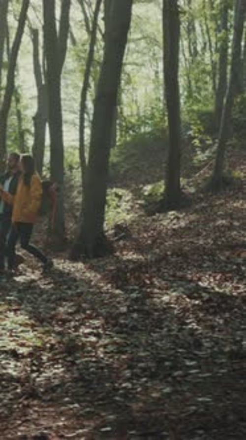 Couple Hiking Together in Autumn Forest