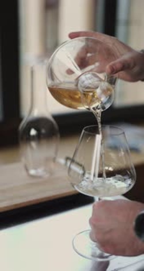 Beverage is Poured into Glass Indoors