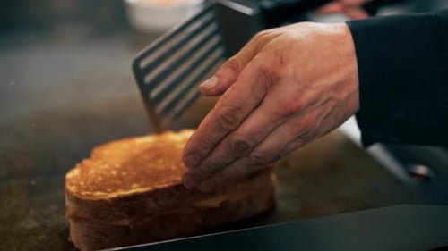 Preparing Golden Grilled Cheese Sandwich on Flat Top