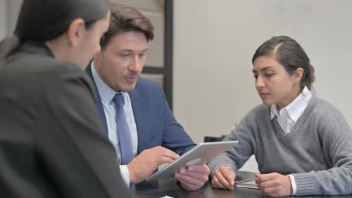 Close up of Business People Working on Digital Tablet
