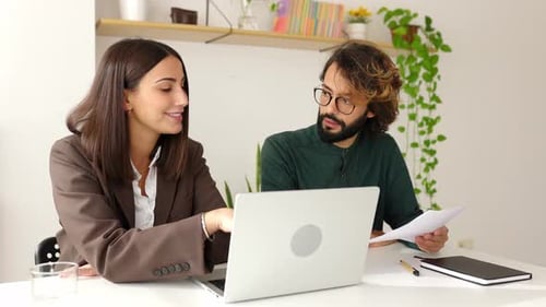 Business Discussion at Workplace with Computer and Paperwork