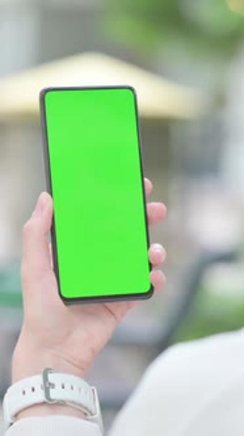 Woman Using Smartphone with Green Screen Outdoor, Vertical Video