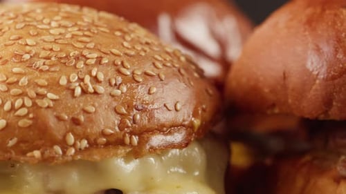 American Fat Smash Burger with Fresh Tomatoes Bacon Slices Fried Onion and Cheese on Grill Closeup