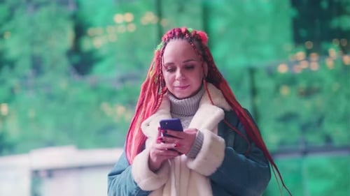 Woman Using Smartphone at Night in City