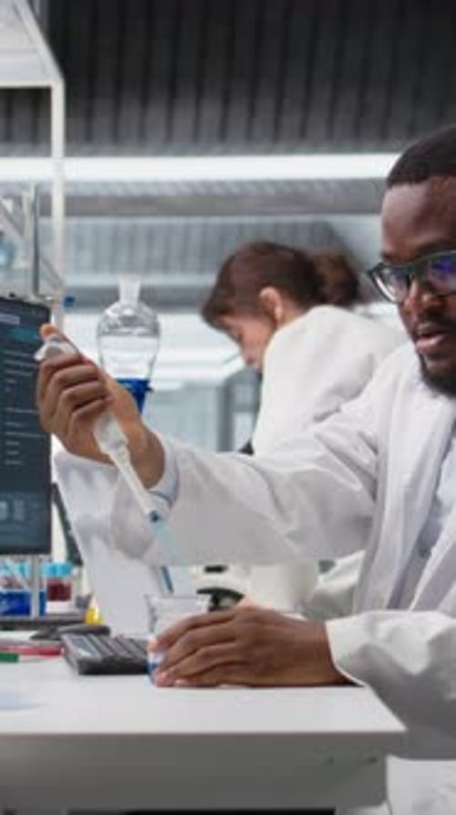 Scientist Conducting Research with Blue Liquid in Lab