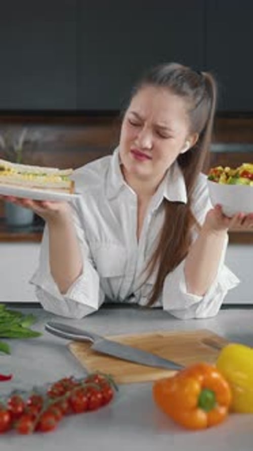 Young Woman Choosing Between Sandwich and Salad
