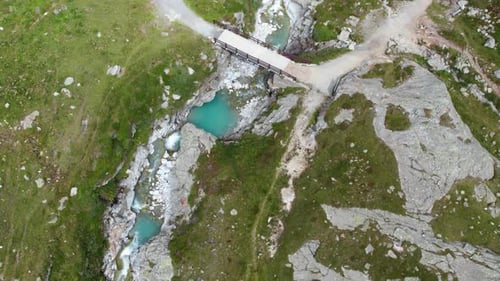 revealing aerial shot of turquoise blue mountain lake high up in swiss alps, beautiful mountain scen