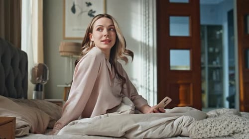 Cozy Girl Typing Mobile Phone in Hotel Bed Dreamy Happy Woman Enjoy Morning