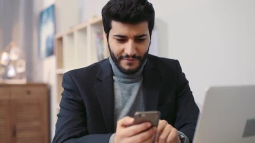 Goodlooking Smiling Man Texting the Message Via His Smartphone Modern Communication Technologies