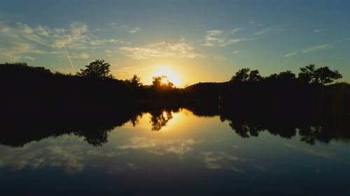 Peaceful Sunset Reflected in Lake